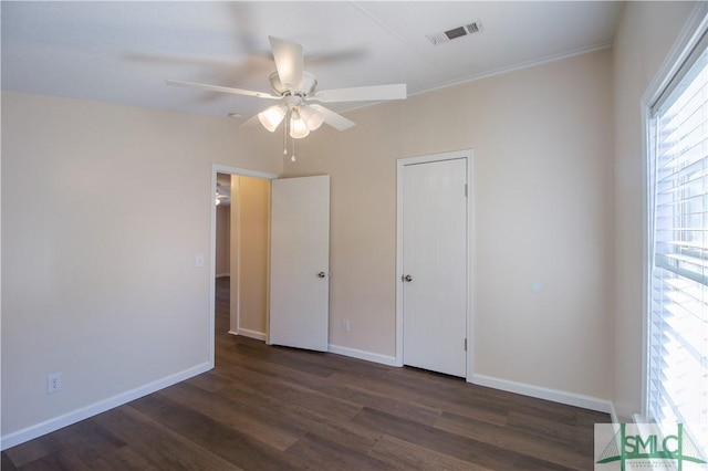 unfurnished bedroom with dark wood-type flooring and ceiling fan