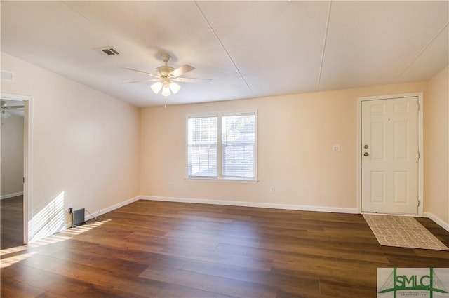 spare room with ceiling fan and dark hardwood / wood-style floors