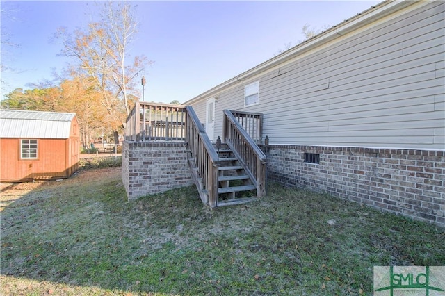 view of yard featuring a wooden deck and a storage shed