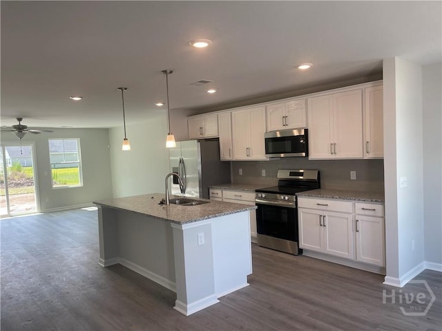 82 Marsh Salt Ln, Port Wentworth, GA 31407 - kitchen featuring appliances with stainless steel finishes, a sink, baseboards, dark wood-style flooring, and backsplash