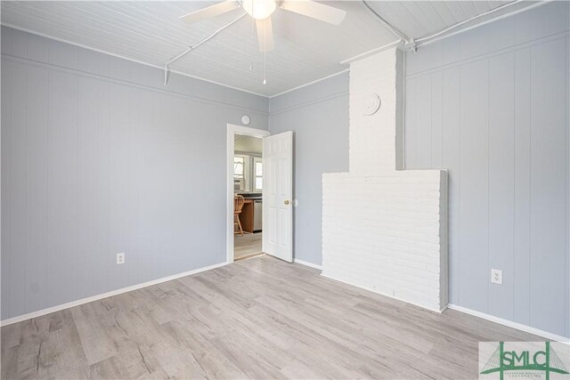 empty room with baseboards, a ceiling fan, and wood finished floors
