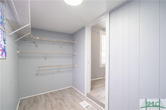 spacious closet featuring visible vents and wood finished floors