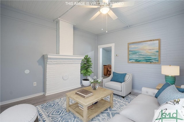living room with baseboards, ceiling fan, and wood finished floors
