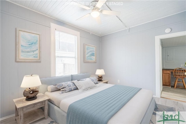 bedroom with a ceiling fan and light wood-type flooring