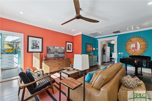 living room with ornamental molding, hardwood / wood-style floors, and ceiling fan