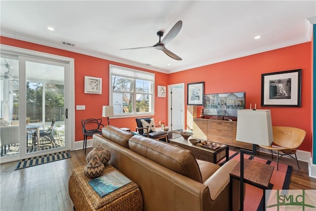 living room featuring crown molding, ceiling fan, and dark hardwood / wood-style floors