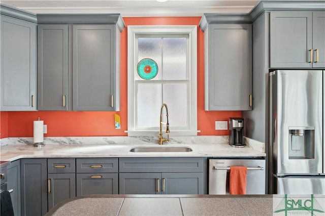 kitchen with stainless steel appliances, sink, and gray cabinetry