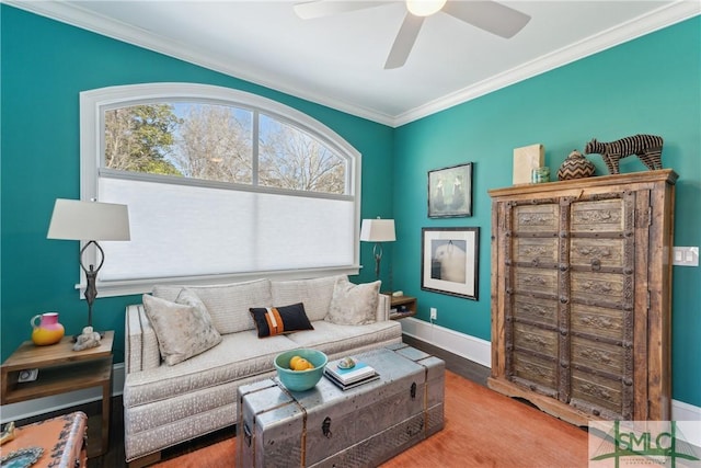 living area featuring crown molding, ceiling fan, and light hardwood / wood-style floors