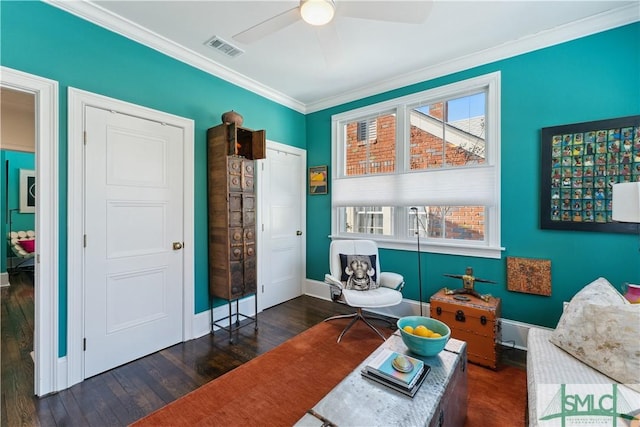 sitting room featuring ceiling fan, ornamental molding, and dark hardwood / wood-style floors