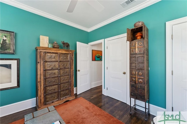 interior space with crown molding, dark wood-type flooring, and ceiling fan