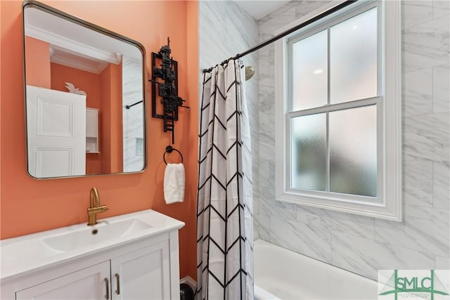 bathroom with ornamental molding, vanity, and shower / tub combo