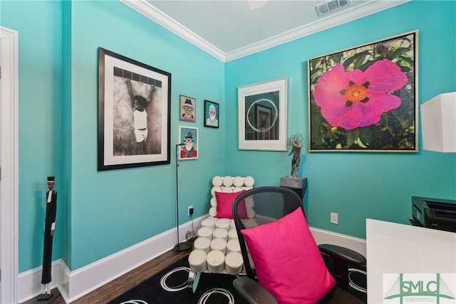 living area with crown molding and hardwood / wood-style flooring