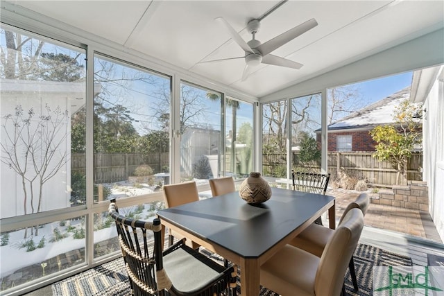 sunroom / solarium featuring ceiling fan