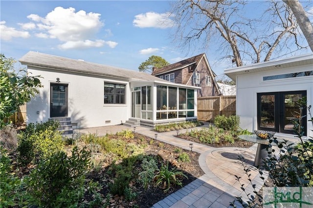 back of house with a patio area and a sunroom