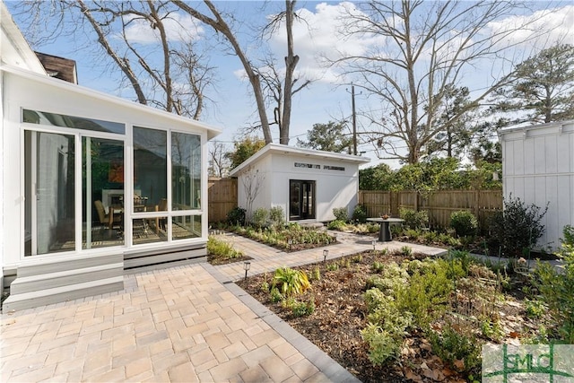 view of yard with a sunroom and an outbuilding