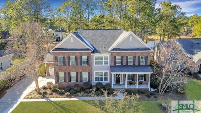 view of front of house with a front yard and covered porch