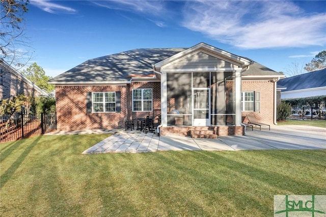 rear view of property with a sunroom, a yard, and a patio