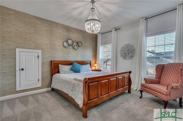 bedroom featuring light carpet and a chandelier