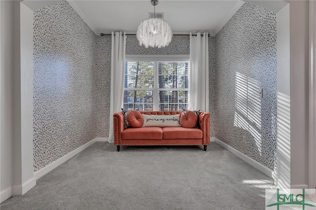 sitting room featuring crown molding, carpet, and a notable chandelier