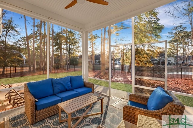 sunroom / solarium featuring ceiling fan