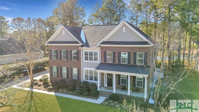 view of front of property with a front yard and a porch