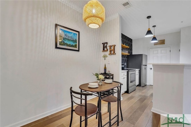 dining area featuring light wood-type flooring