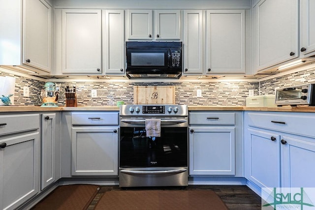 kitchen featuring tasteful backsplash, white cabinetry, wood counters, and stainless steel range with electric stovetop