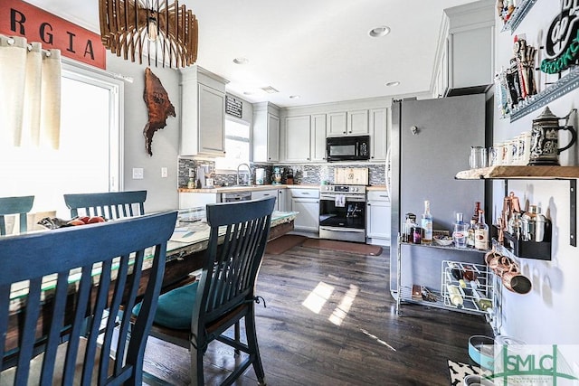 kitchen with sink, decorative backsplash, dark hardwood / wood-style floors, and appliances with stainless steel finishes