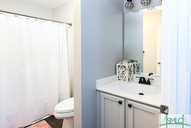 bathroom featuring vanity and toilet