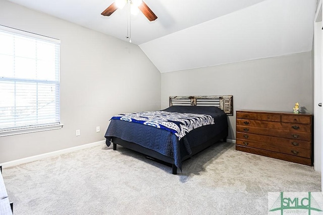 carpeted bedroom with ceiling fan and lofted ceiling