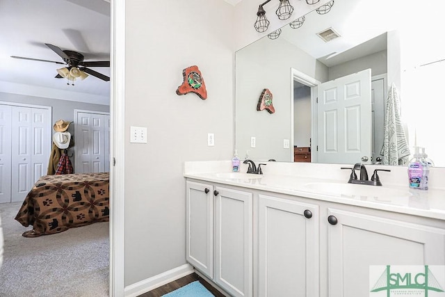 bathroom with ceiling fan and vanity