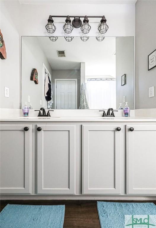 bathroom featuring vanity and wood-type flooring