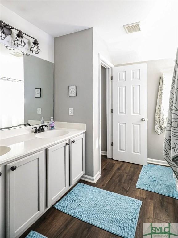 bathroom with hardwood / wood-style flooring and vanity