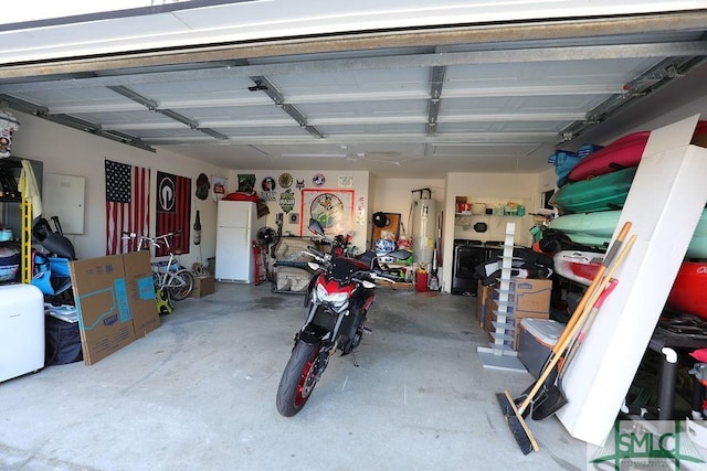 garage featuring white refrigerator and electric water heater