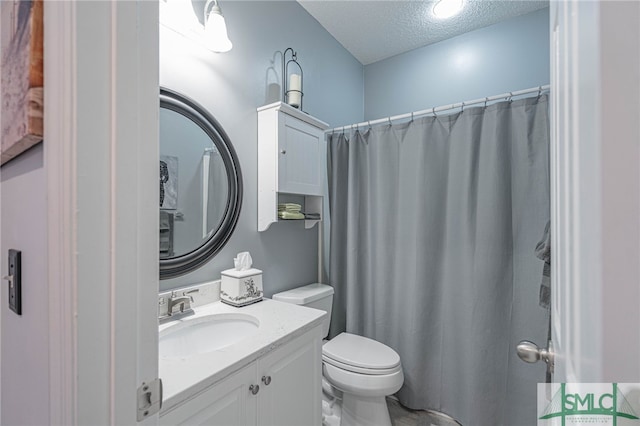 bathroom featuring vanity, toilet, a textured ceiling, and walk in shower