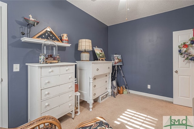 bedroom with ceiling fan, light carpet, and a textured ceiling