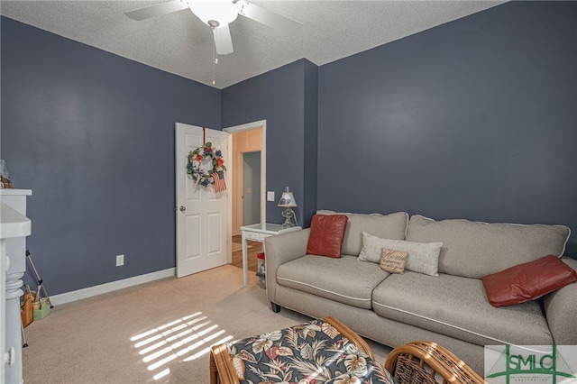 carpeted living room with ceiling fan and a textured ceiling