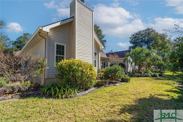 view of home's exterior with a yard