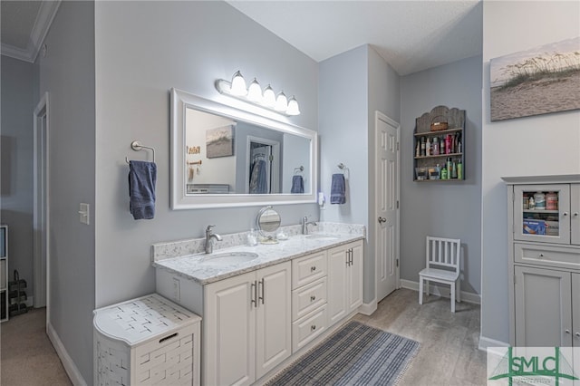 bathroom featuring vanity, a textured ceiling, and crown molding