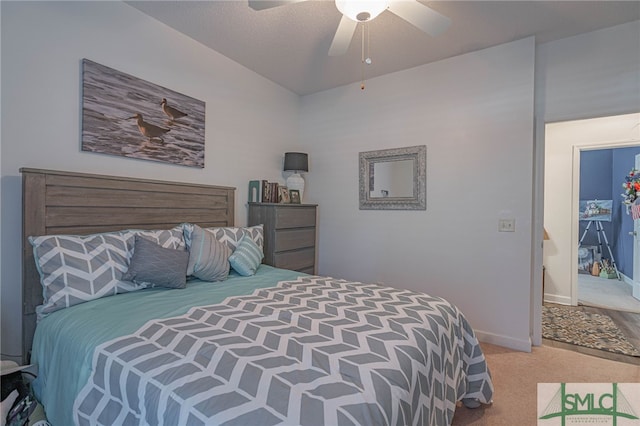 bedroom with a textured ceiling, light colored carpet, and ceiling fan