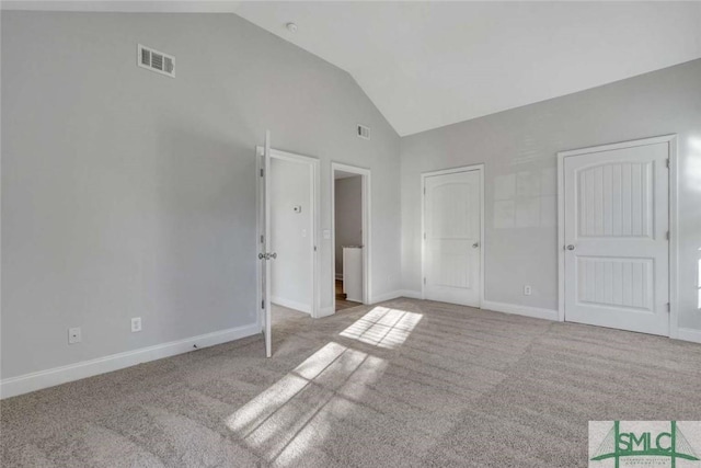 unfurnished bedroom with lofted ceiling and light carpet