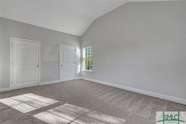 unfurnished bedroom featuring lofted ceiling and carpet