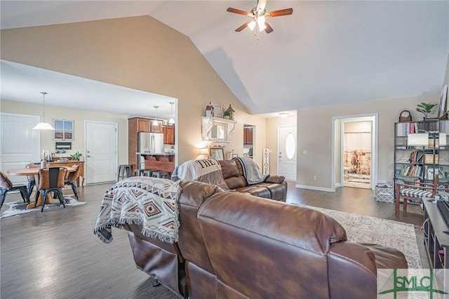 living room featuring vaulted ceiling, ceiling fan, and dark hardwood / wood-style flooring