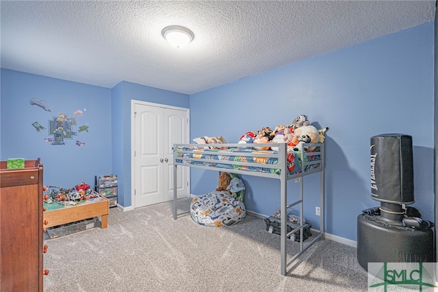 bedroom with carpet and a textured ceiling