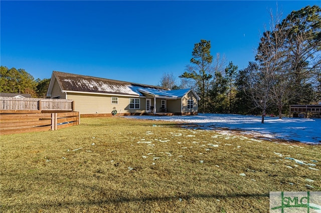 rear view of house featuring a lawn