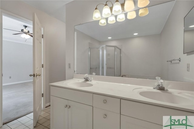 bathroom with ceiling fan, tile patterned floors, a shower with shower door, and vanity