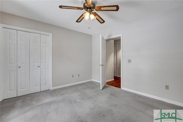 unfurnished bedroom featuring carpet floors, a textured ceiling, ceiling fan, and a closet