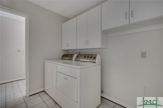 washroom with cabinets, independent washer and dryer, and light tile patterned flooring