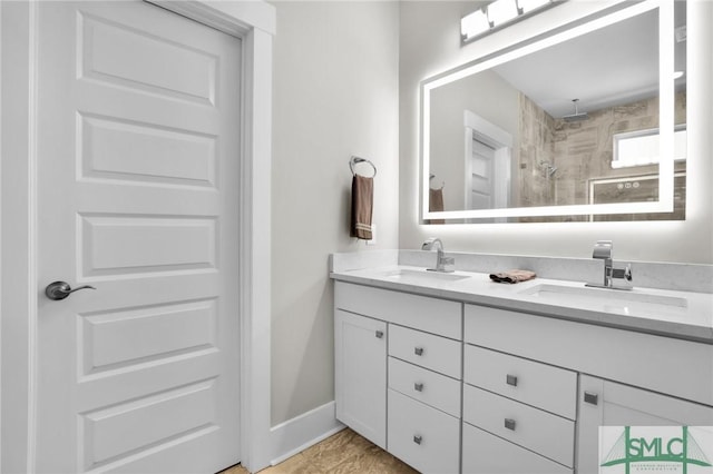 bathroom featuring vanity and tiled shower