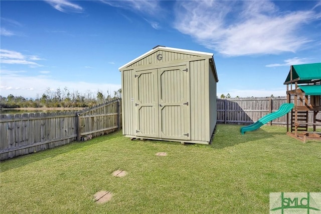 view of outbuilding with a playground and a yard